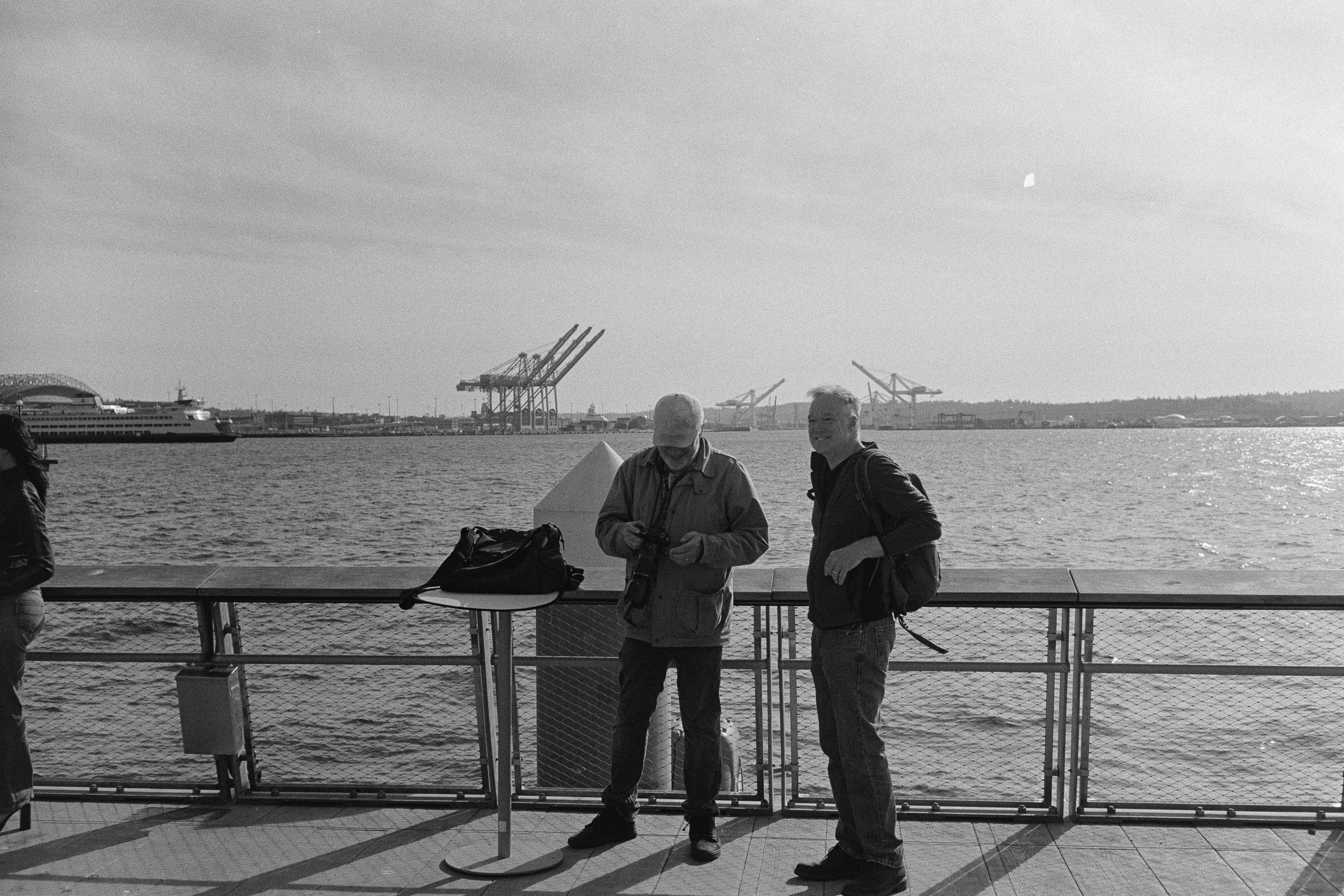 Two photographers at the pier rail