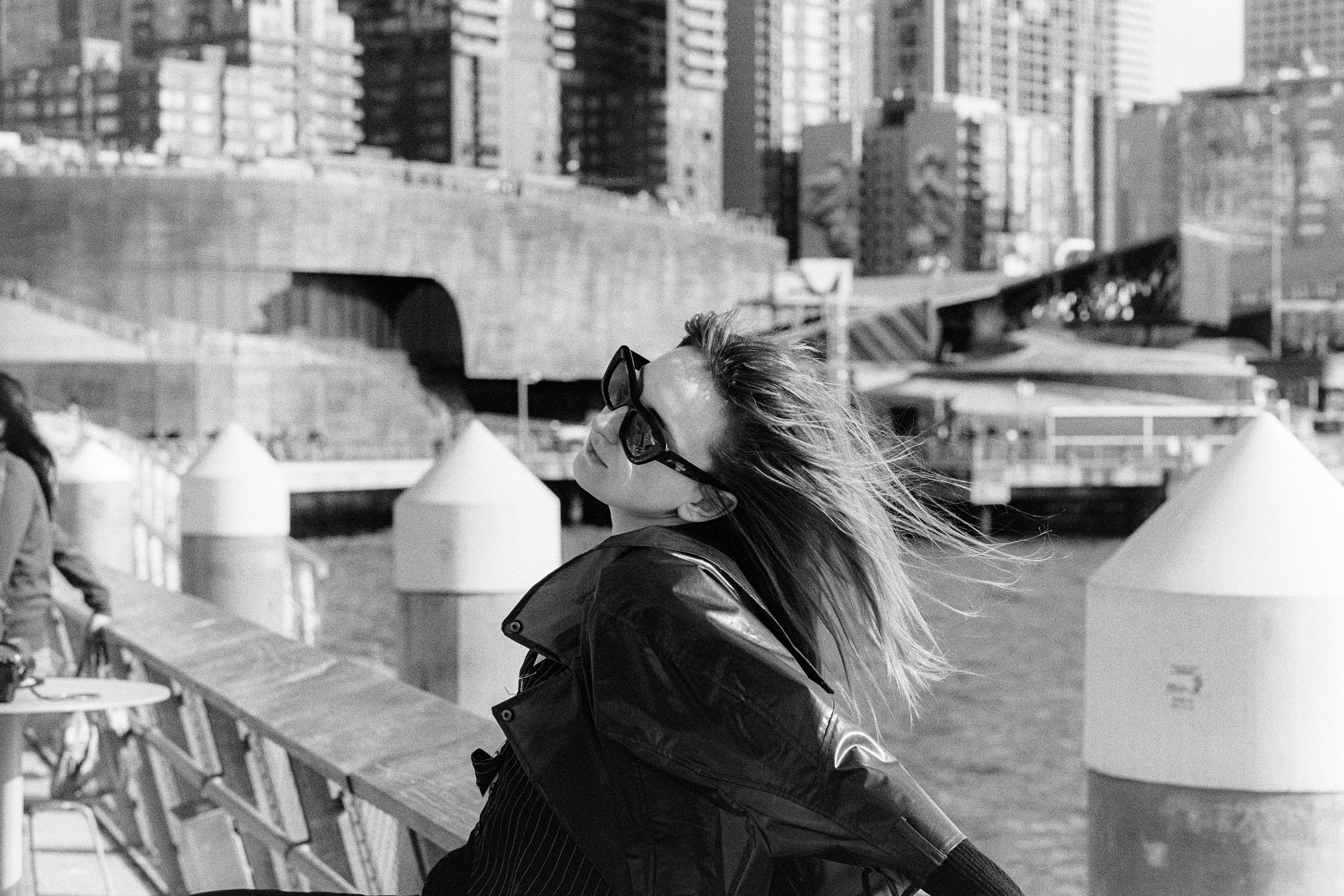 Sunglasses and downtown buildings, wind in the hair