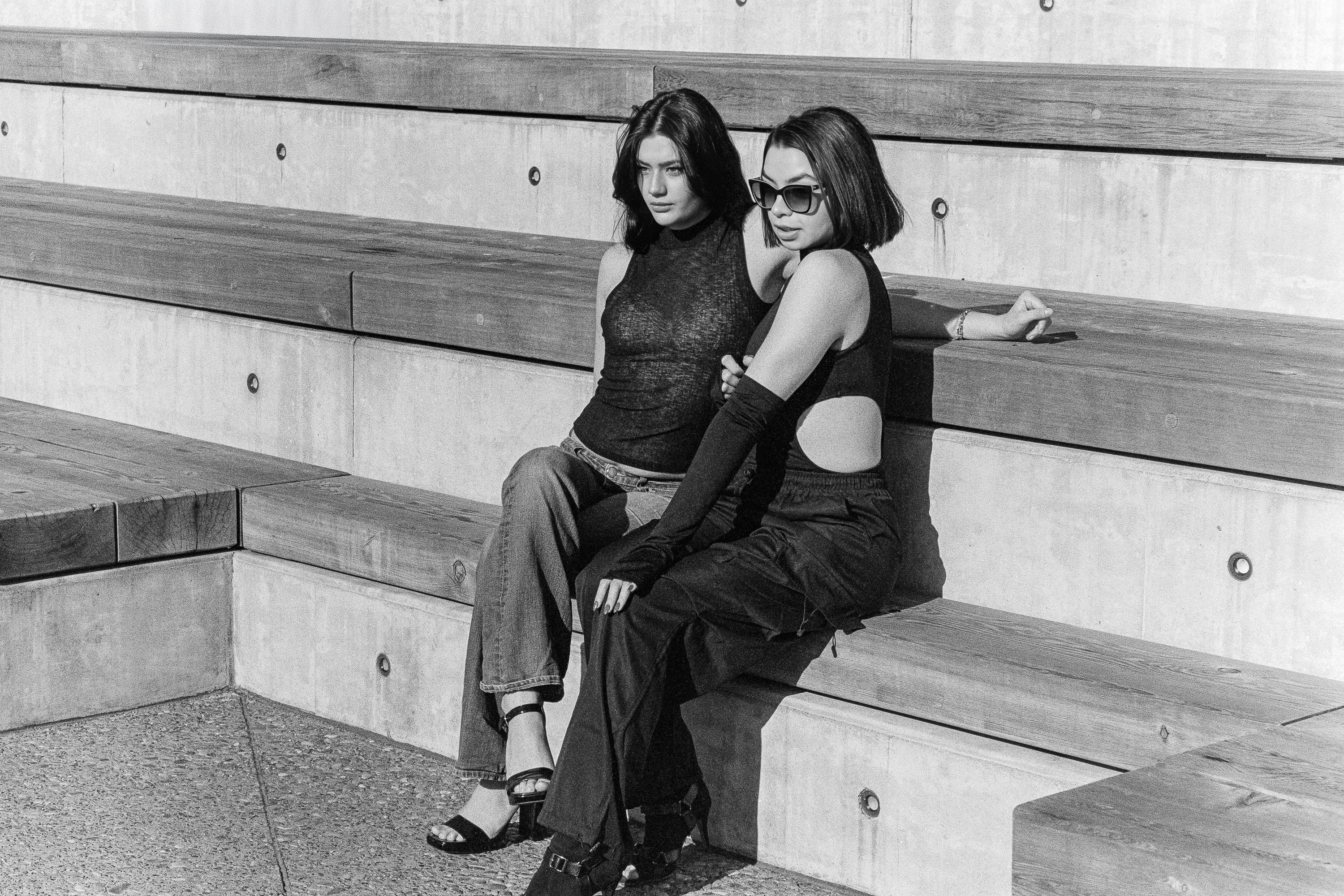 Two models seated, leaning together