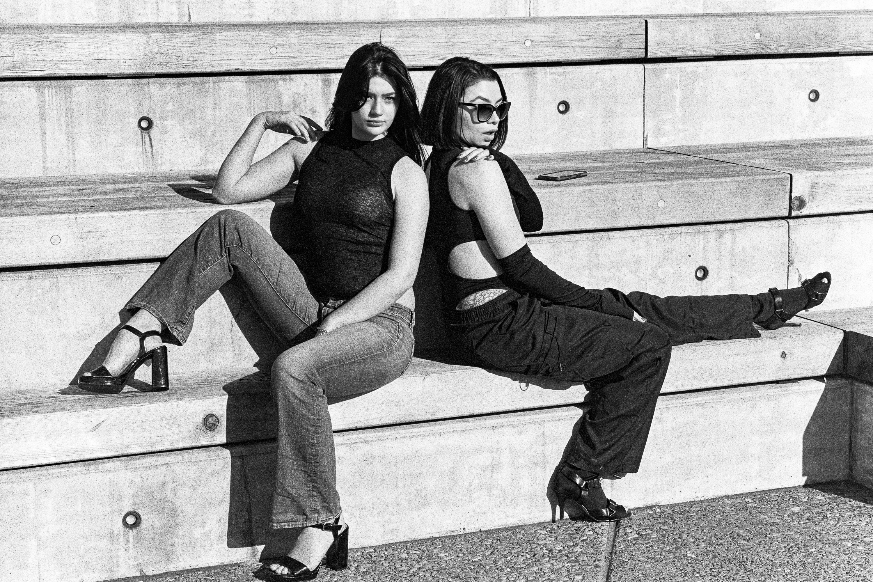 Two models seated on the bleachers