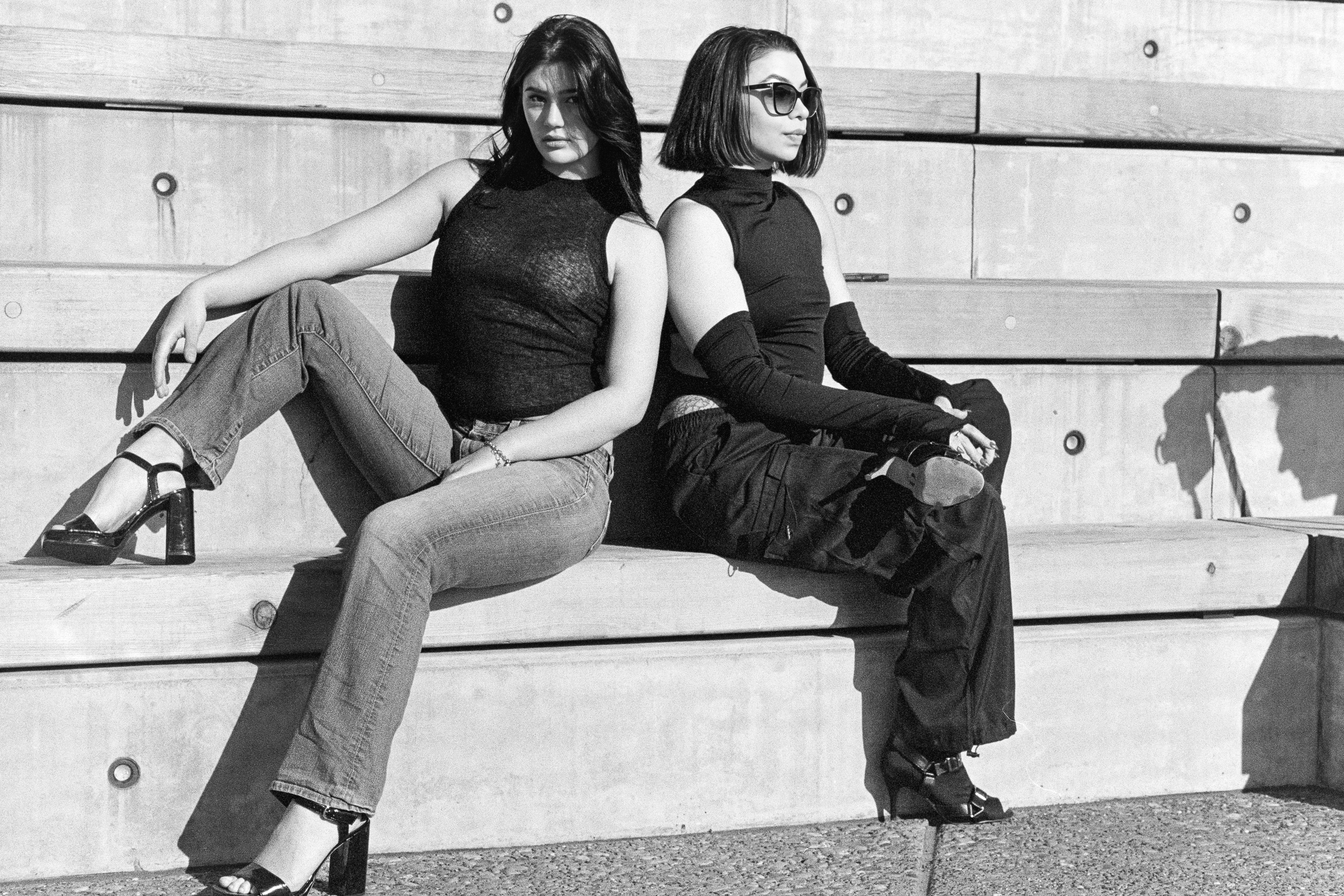 Two models leaning against the wall